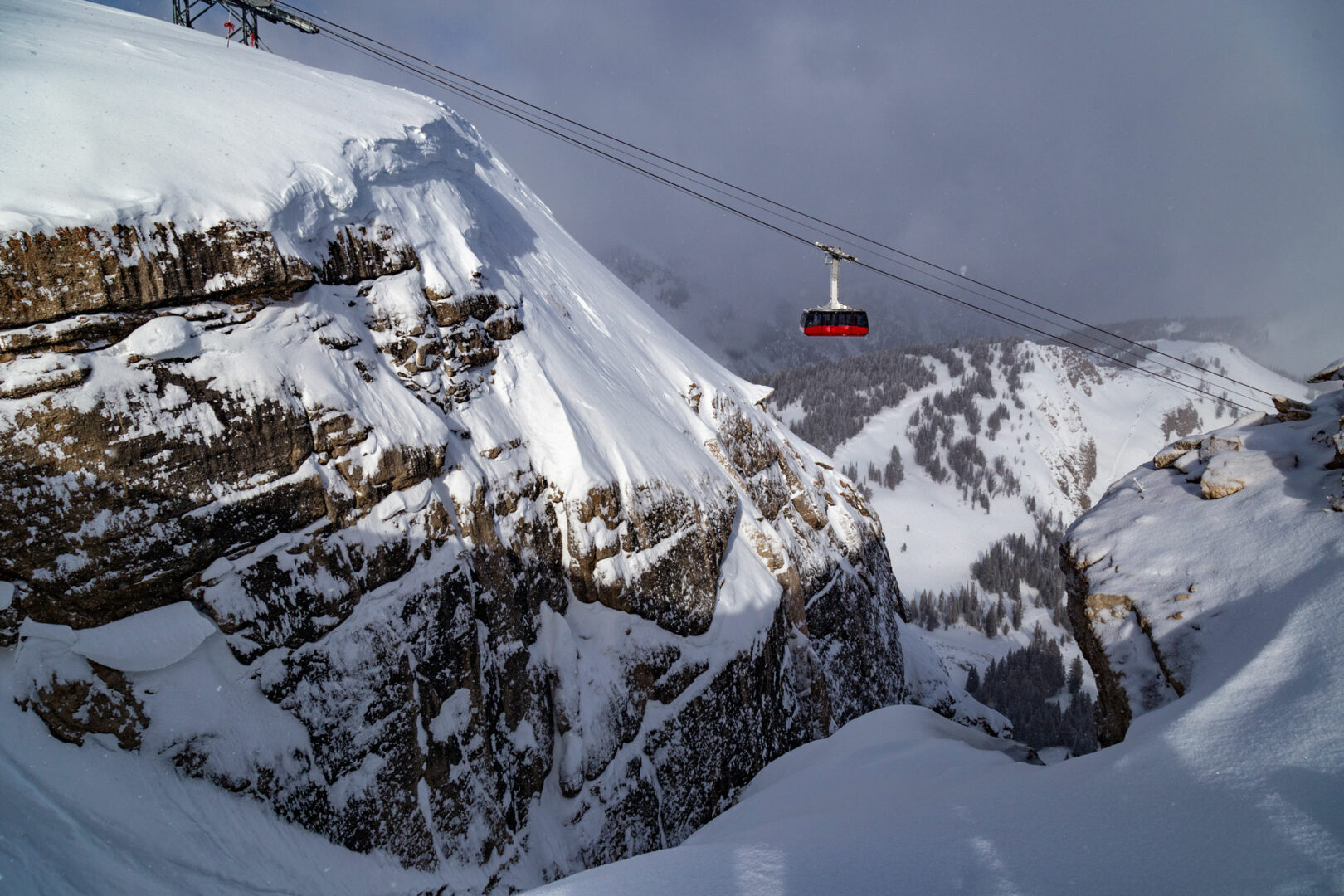 a snowy mountain with a car from the Jackson Hole Mountain Resort Aerial Tram