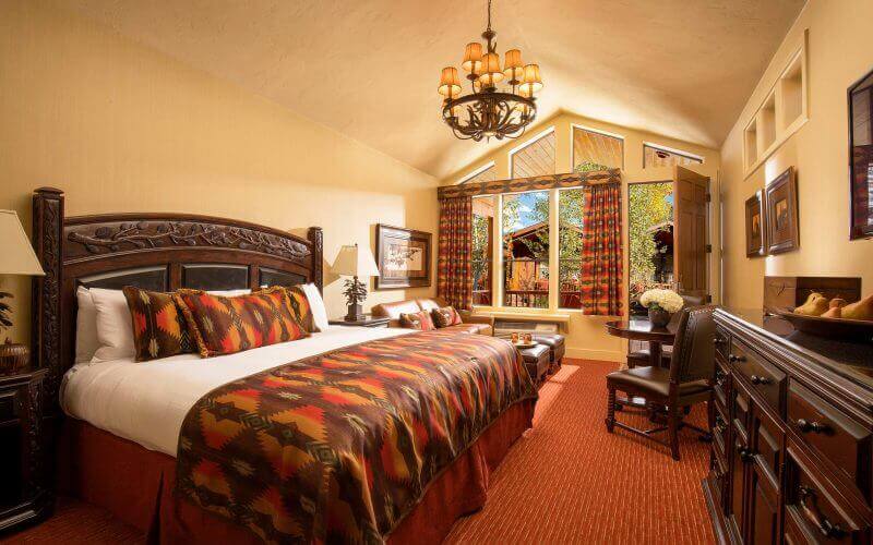 luxury hotel room with leather couches and king size bed