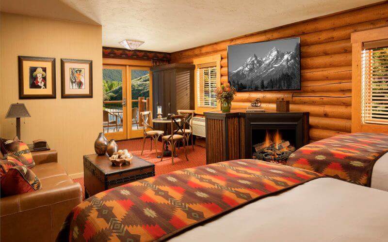 luxury hotel cabin with two queen beds and fireplace
