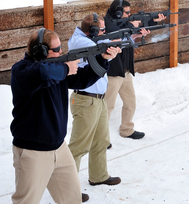 Men with automatic weapons at a shooting range in winter