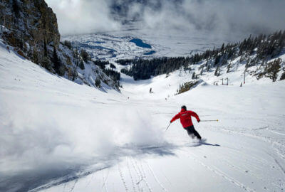 Man skiing down a mountain in the snow