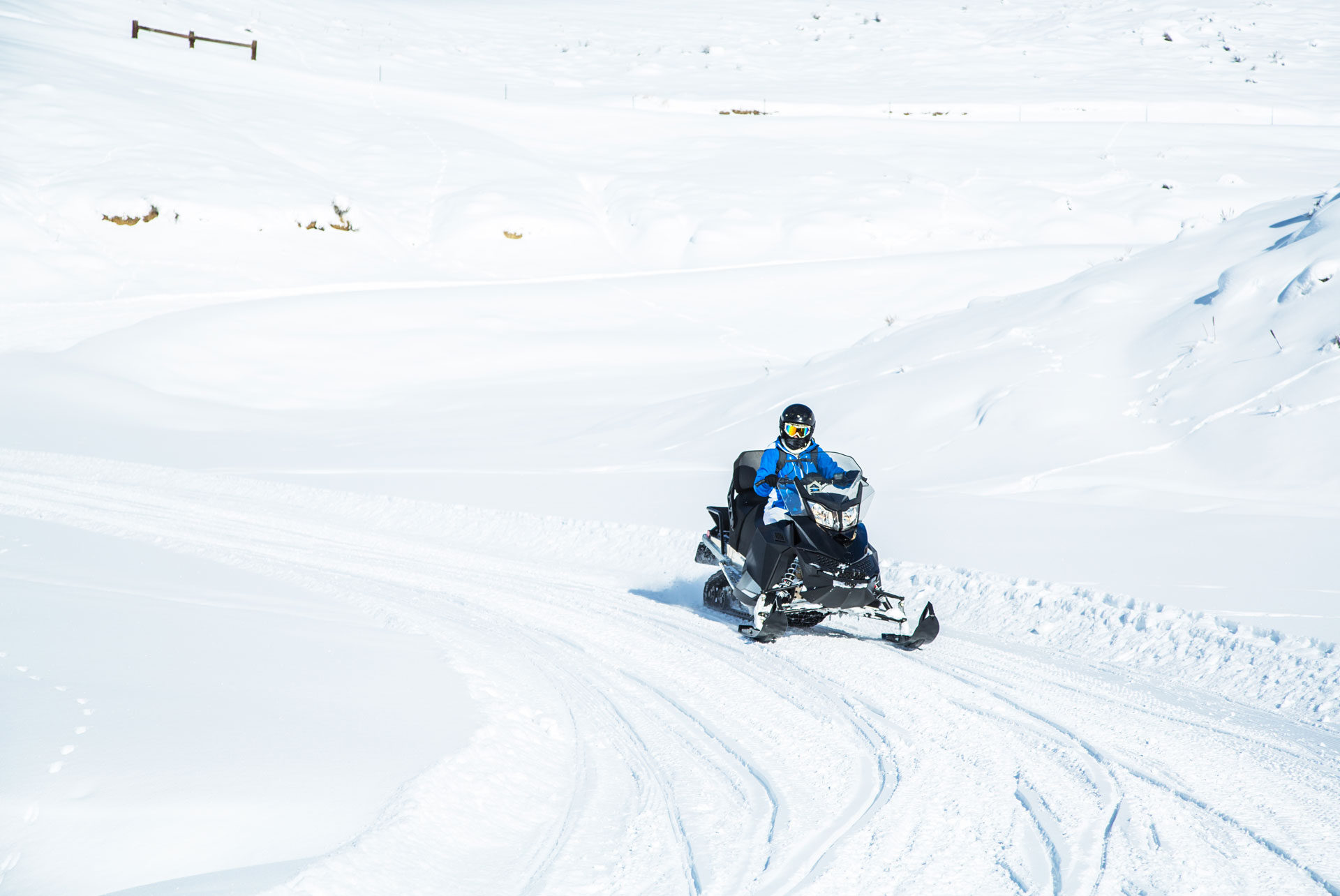 person snowmobiling with snow all around