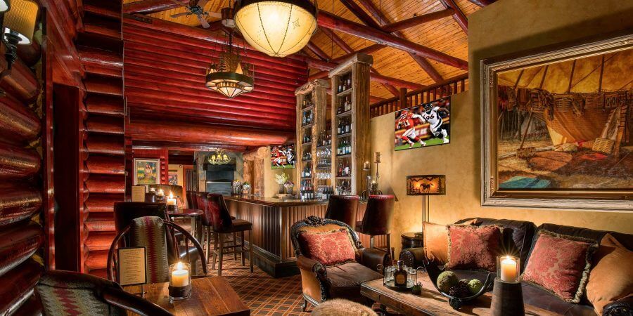 Rustic Inn bar decorated with log beams and wood furniture