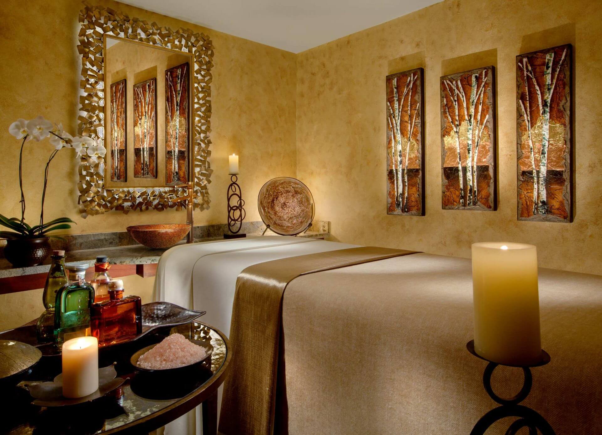 massage room with candles, salts and oils on a table