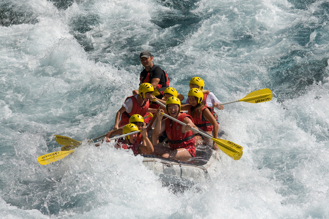 A group of people rafting on the river
